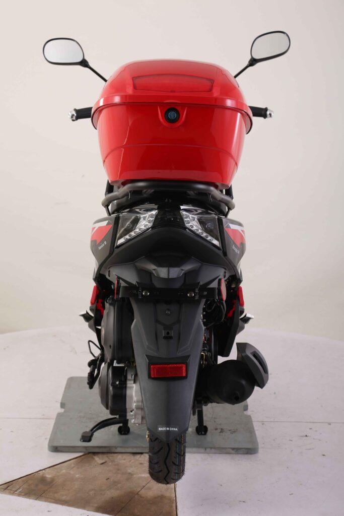 Red motorcycle on a white platform with a white background Scooter Moped Street legal for adults
